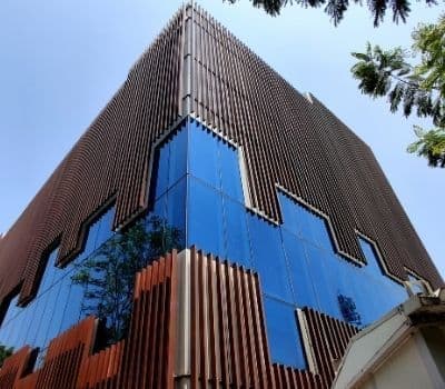 Building facade with glass and fluted wpc panels