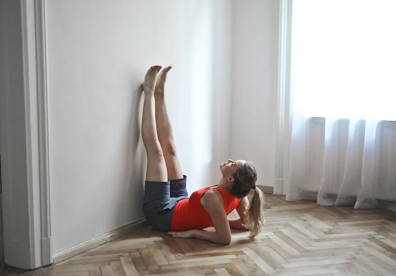 woman doing the legs-up-the-wall yoga pose