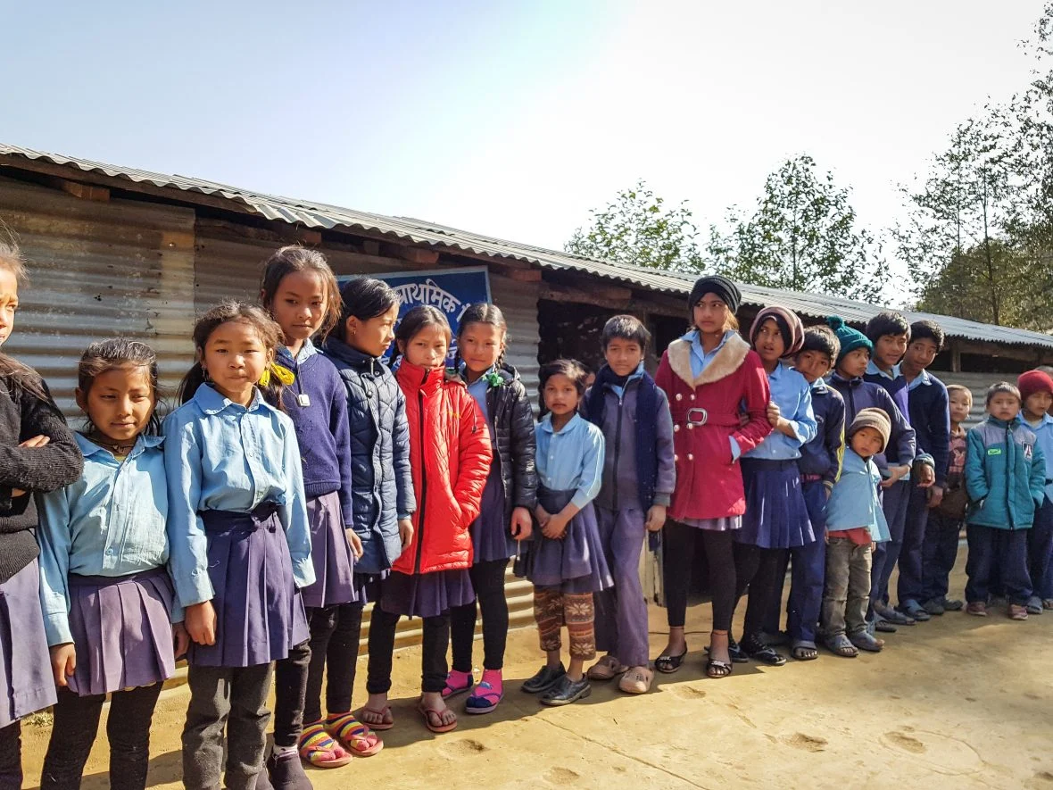 Schoolchildren outside a temporary school structure in Nepal.