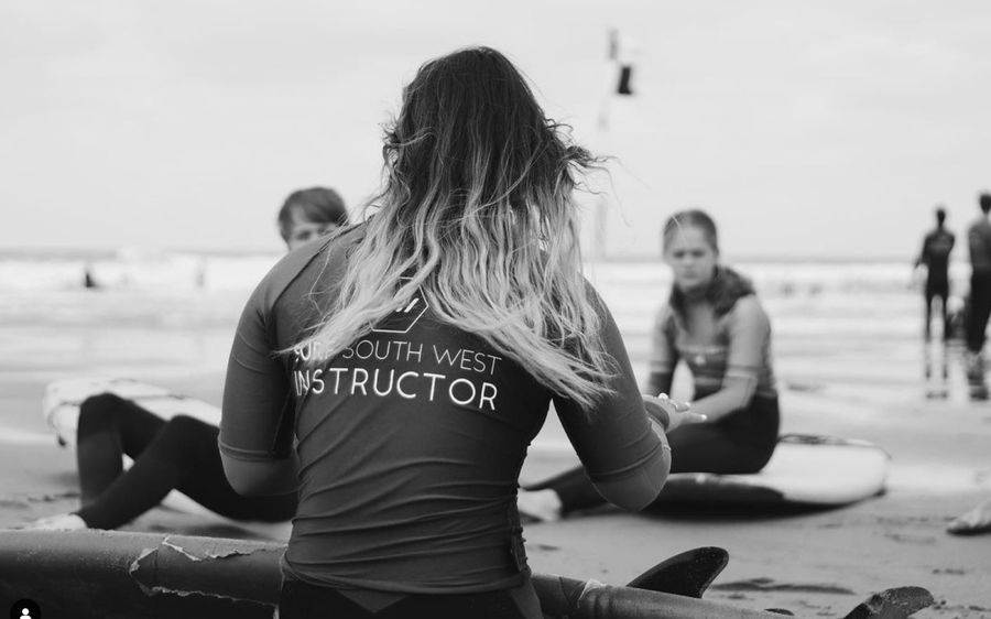 teacher teaching surfing