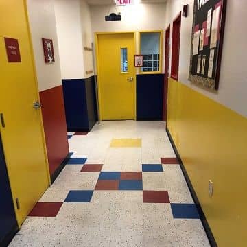 yellow painted doors with a red, blue, and yellow strip painted wall