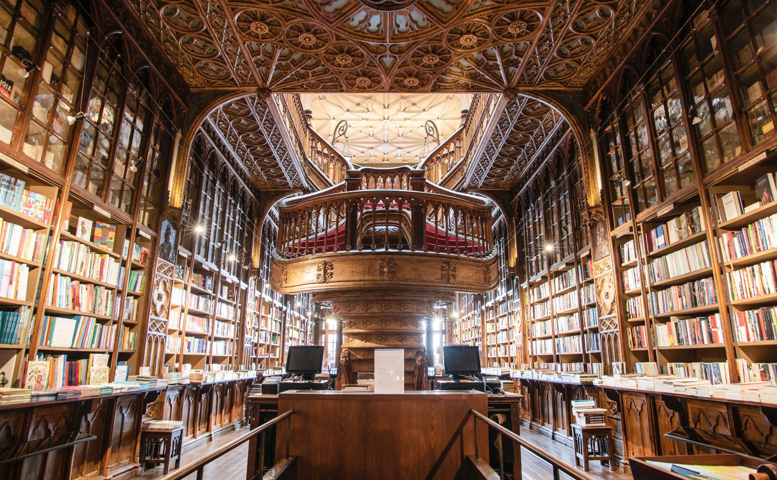 brown wooden bookshelves in the Livraria Lello in portugal
