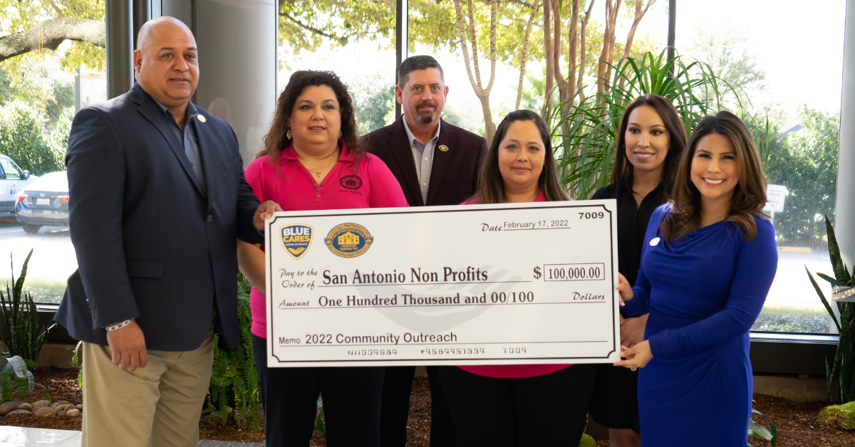 Photo of San Antonio Police Officers Association holding a large check for $100,000 for local nonprofits