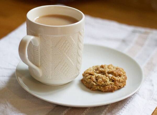 Mug of coffee and biscuit