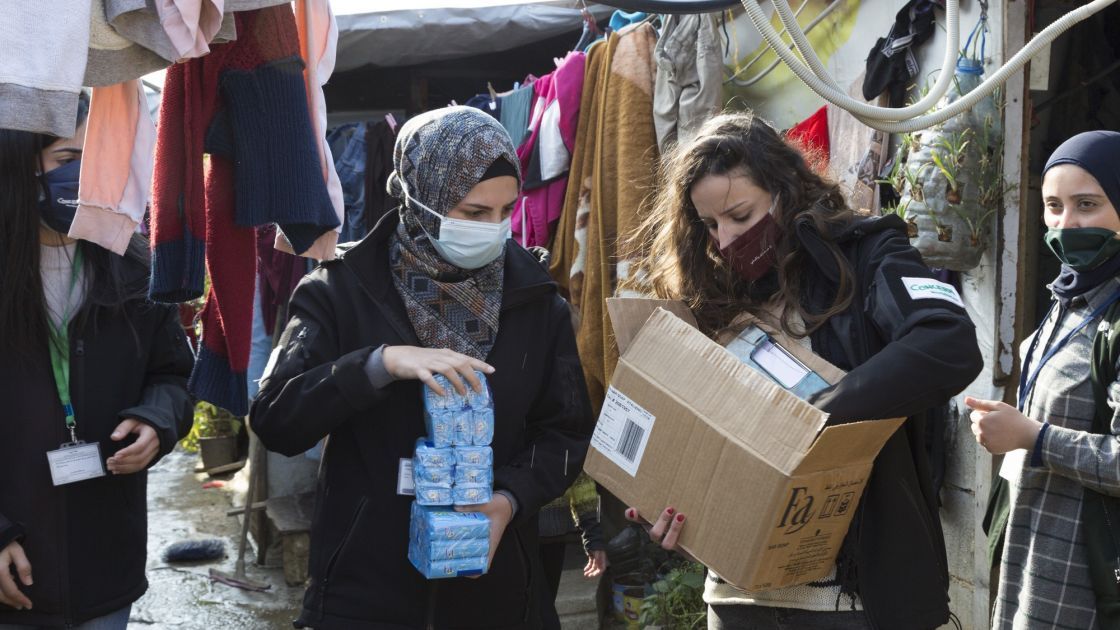 Team members of Concern Lebanon distribute soap at an informal tented settlement hosting Syrian refugees