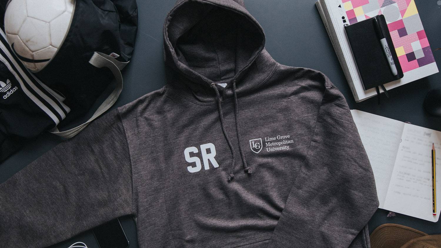 A personalised charcoal grey university hoodie laid out on a table