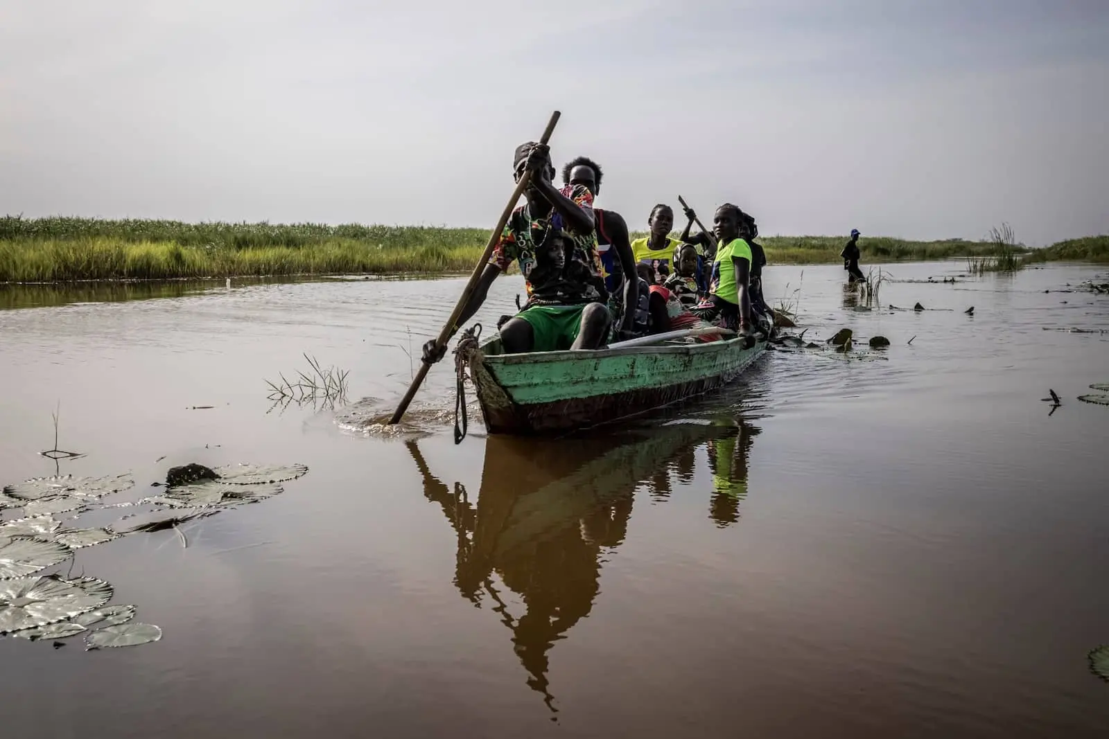 Displaced people travel through floods in South Sudan by boat