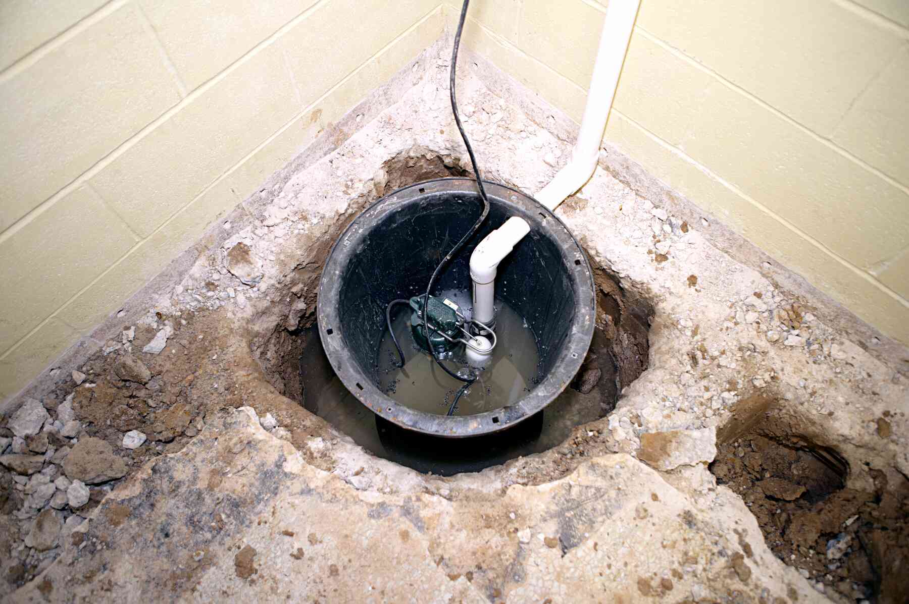 Sump pump basin with pvc pipe