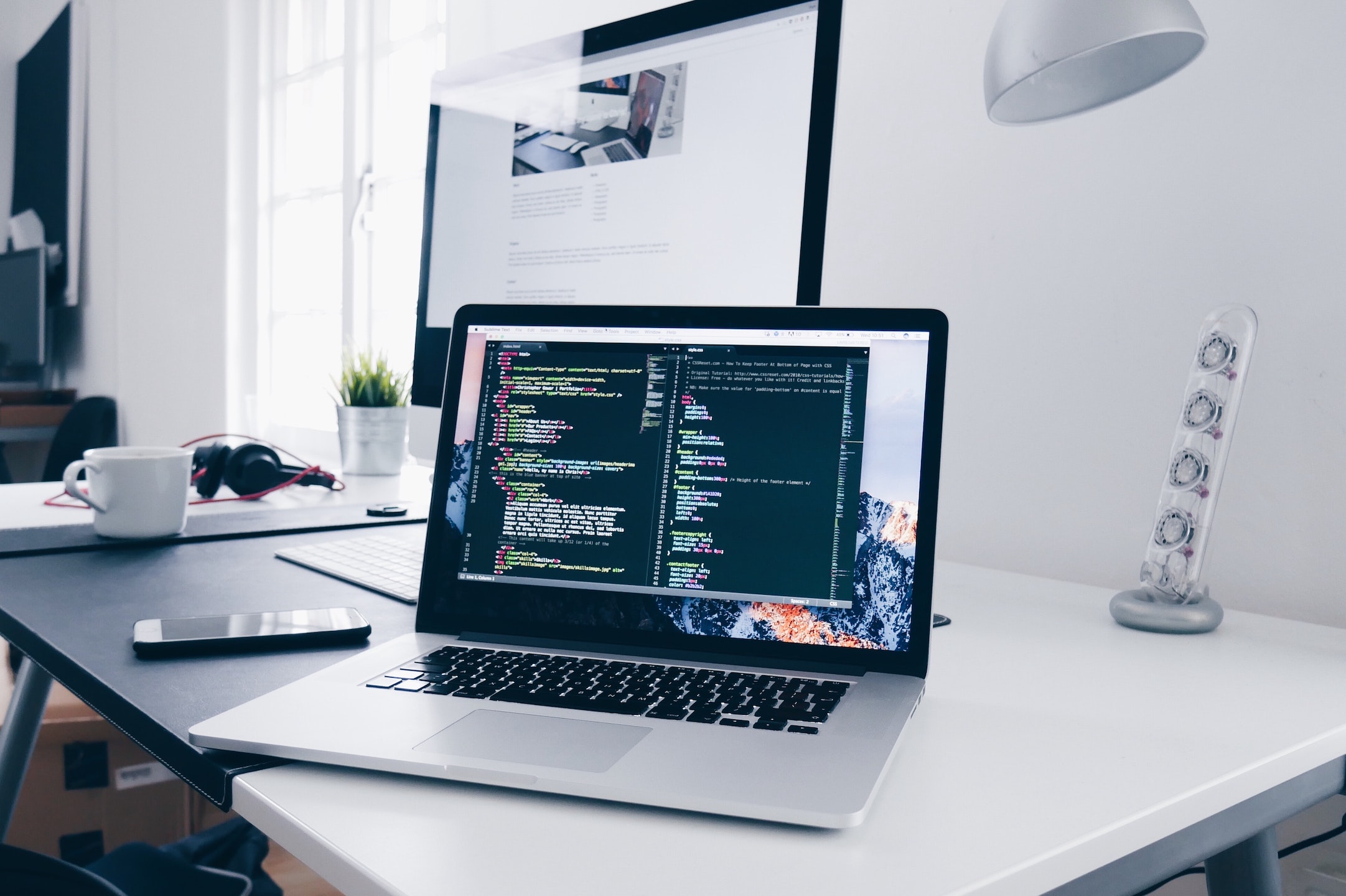 Open Apple Laptop with Code on Desk