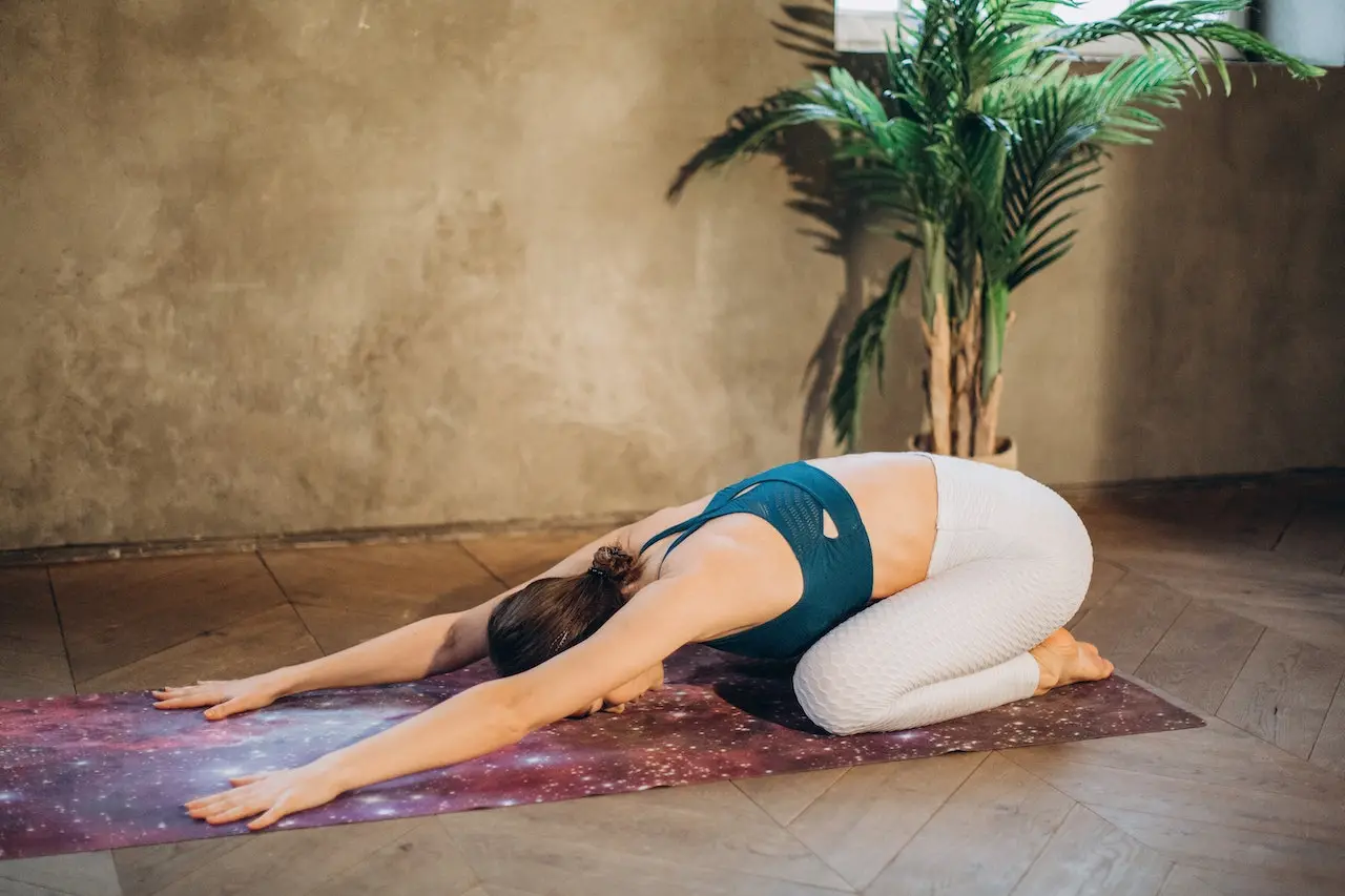 Woman in child's yoga pose