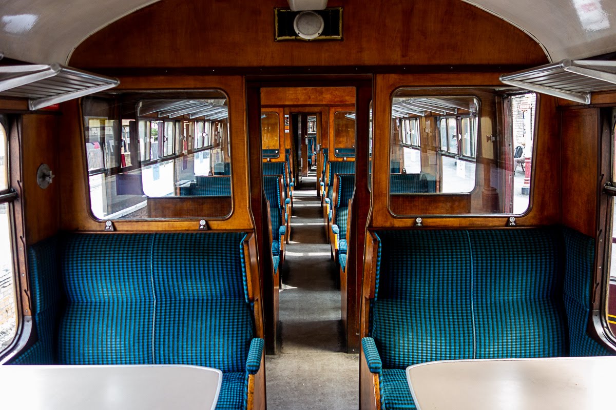 plush blue seats inside the keighley train
