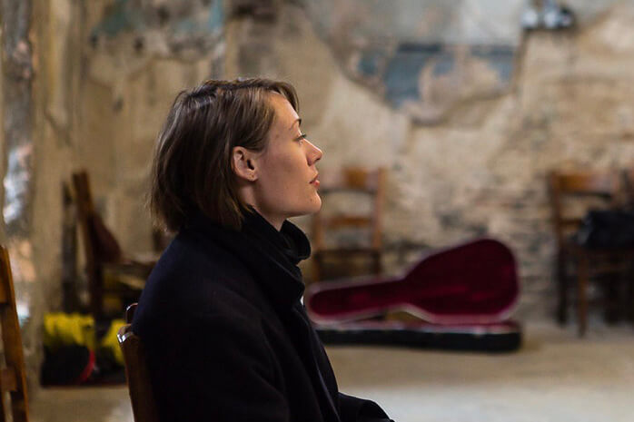 pensive image of Lisa Illean in a rehearsal space as she contemplates