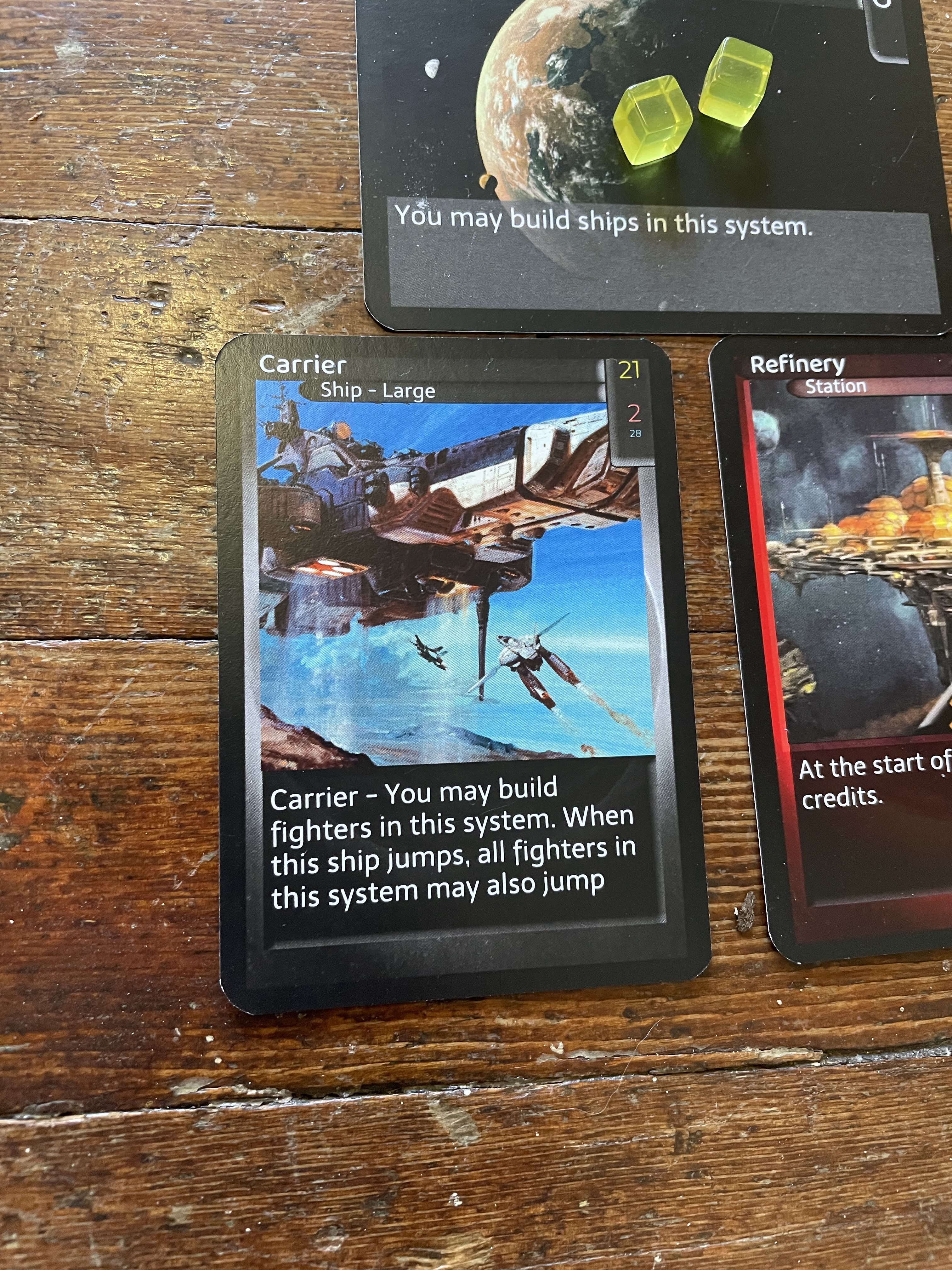 A Carrier ship is placed beneath the Homeworld system card.