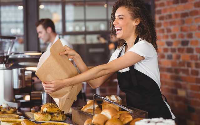 Happy girl serving customers