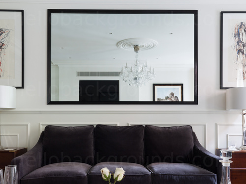 Classically styled living room featuring black sofa with large mirror on rear wall Google Meet background