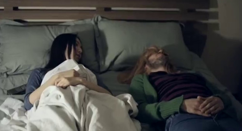 From the indie film, 'Follow Follow', a screenshot of a young woman, Even, lying in bed with Kurt Cobain.