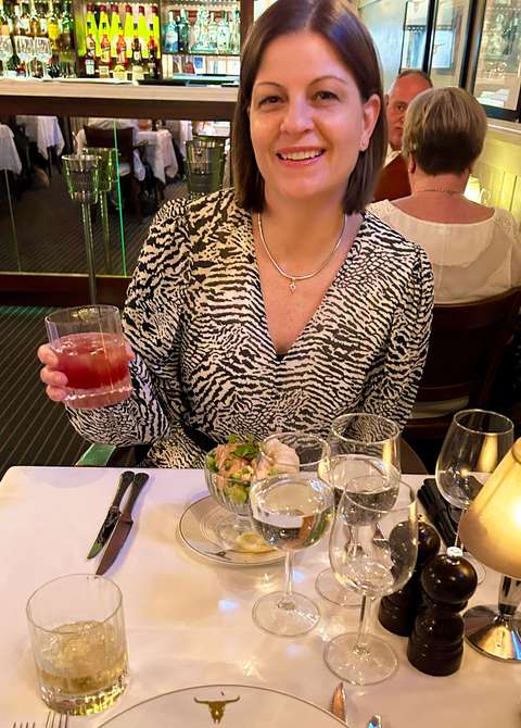 My wife sipping an apéritif at the London Steakhouse.