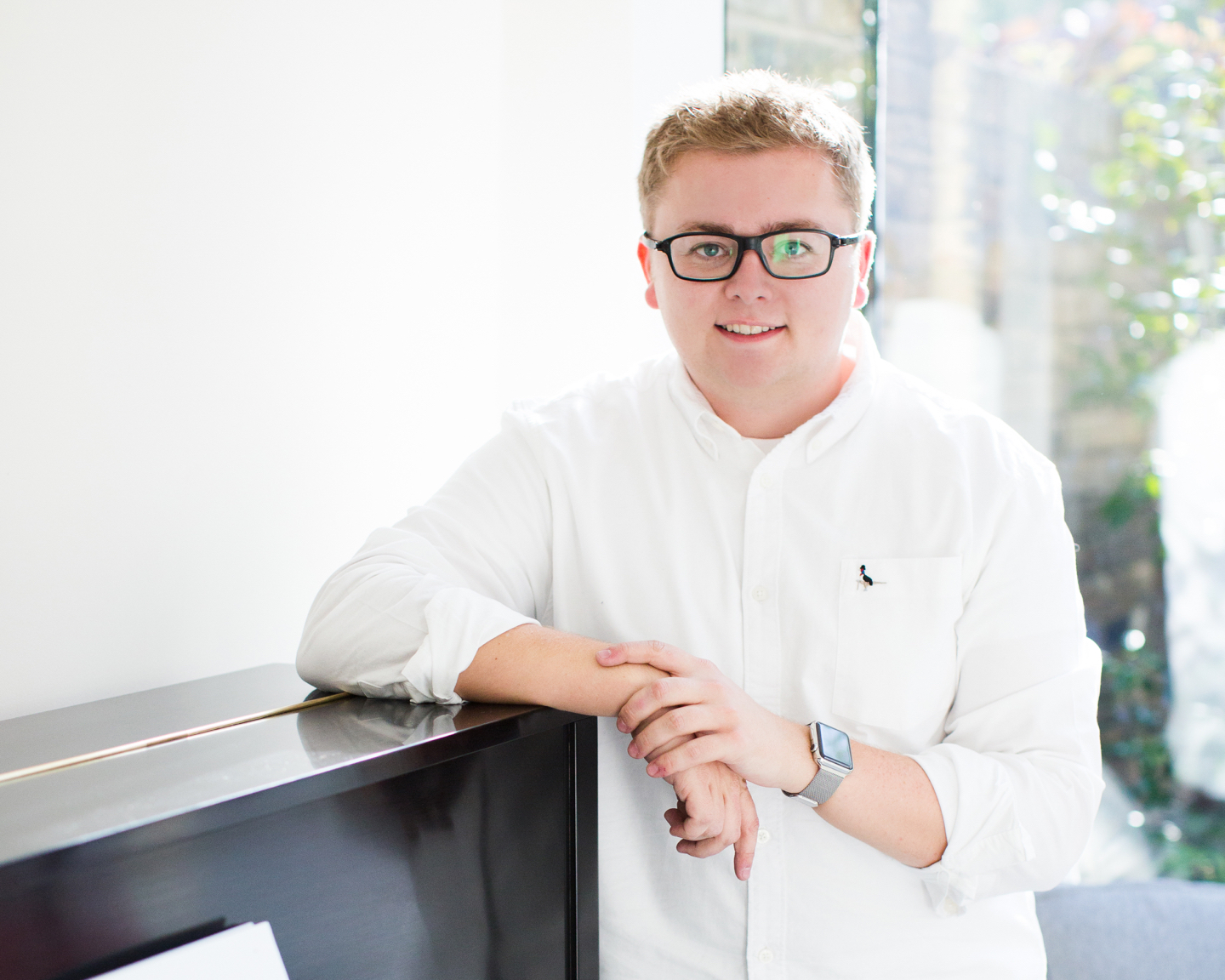 Jack Watkins leaning on his piano