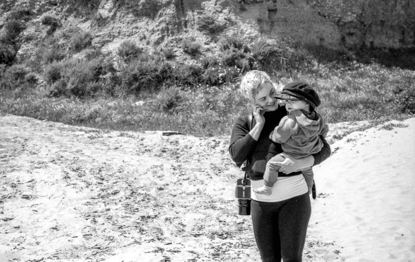 A woman and baby enjoying the beach