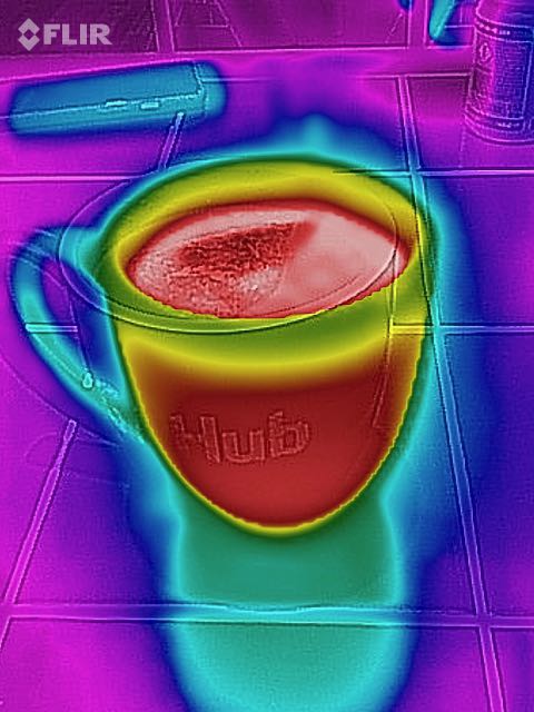 A mug of tea, showing where the liquid is hot and the mug itself is
    warmiing up