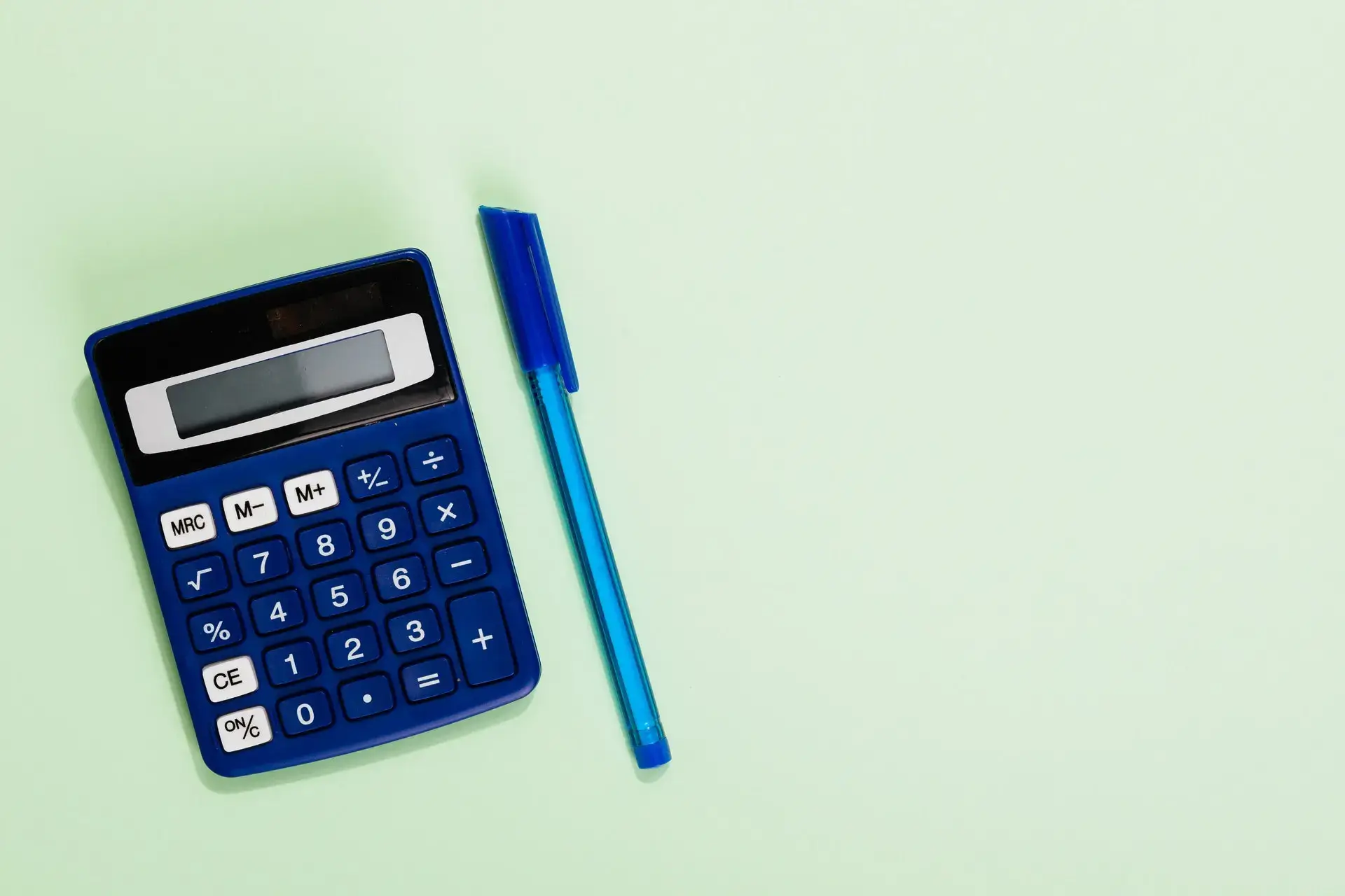 A picture of a calculator and a pen