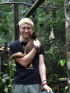 The author in the rainforest holding a monkey