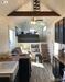 Internal view of the gooseneck tiny house from Breckenridge, Texas showing an exposed beam overhead, natural wood worktops in the kitchen and six steps up to the bedroom area. Internal view of the gooseneck tiny house from Breckenridge, Texas showing an exposed beam overhead, natural wood worktops in the kitchen and six steps up to the bedroom area.