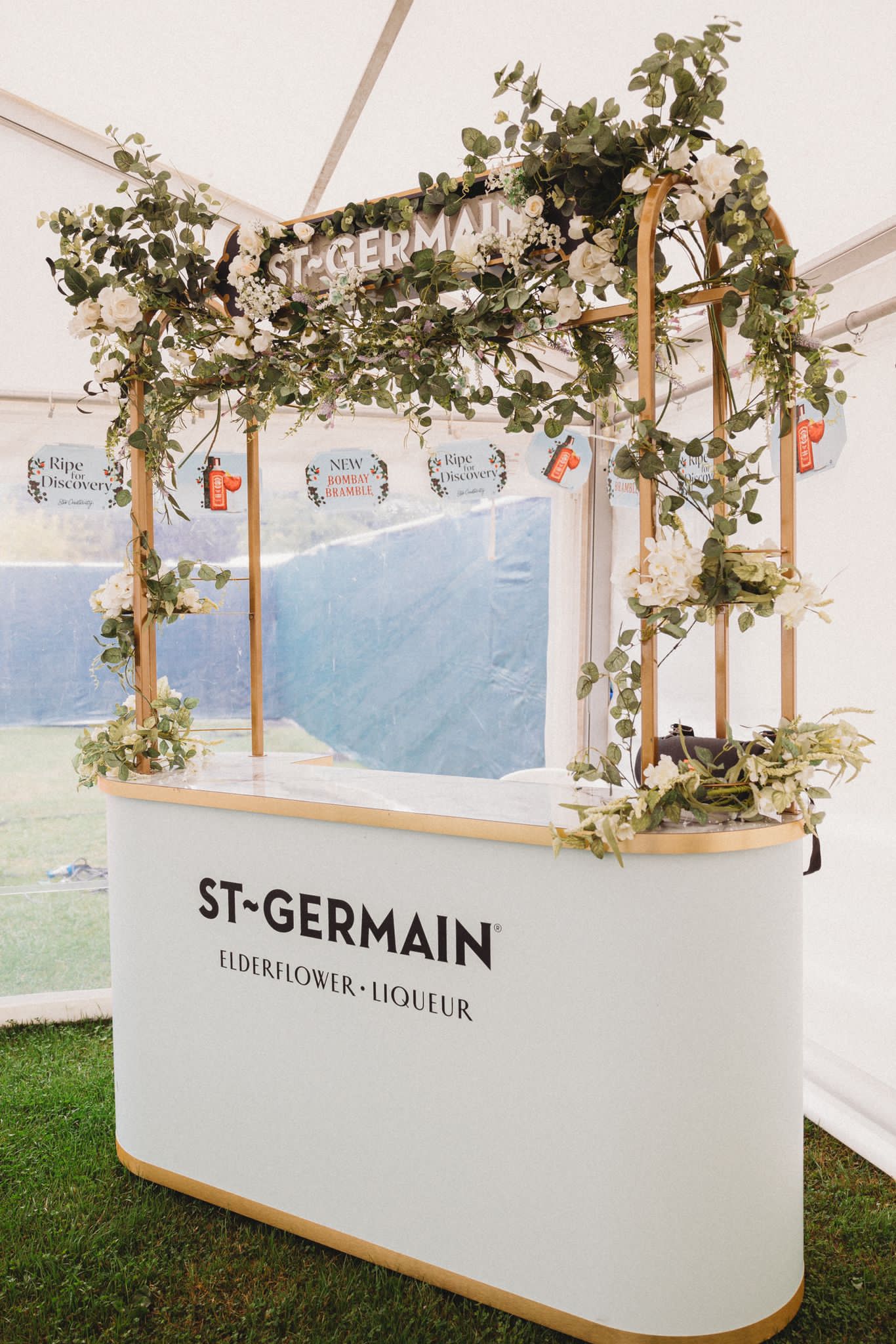 gin bar stand with flowers at wedding venue