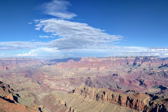 A view along the Grand Canyon from the South Rim, almost parallel to the Colorado River's course. The River itself is barely visible in a steep gorge near the center of the Canyon.
