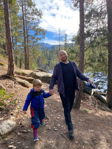 Yev with his Son walking through a forrest