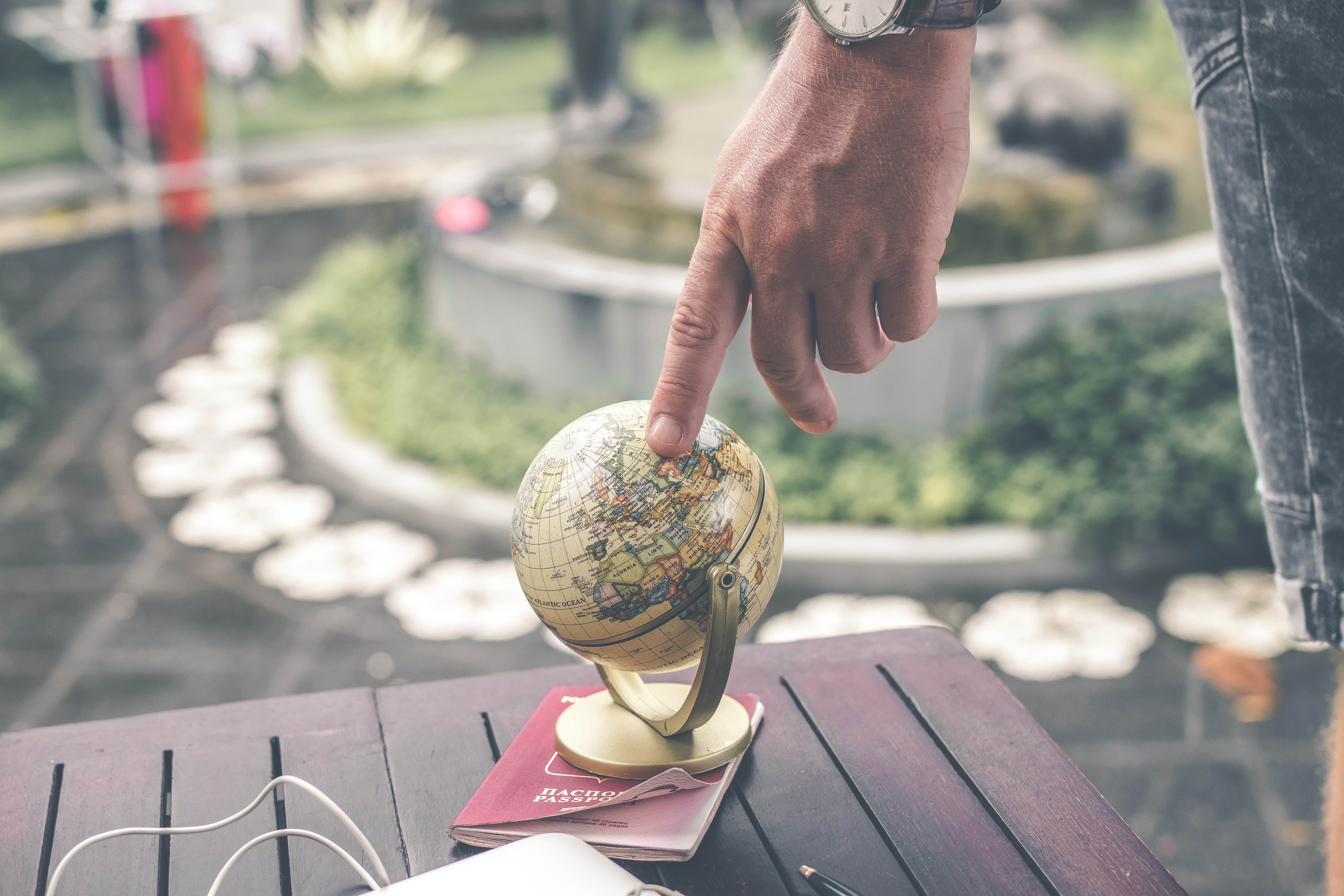 finger pointed to globe representing the article Tricks to Make your Gatsby Localization Project a Success