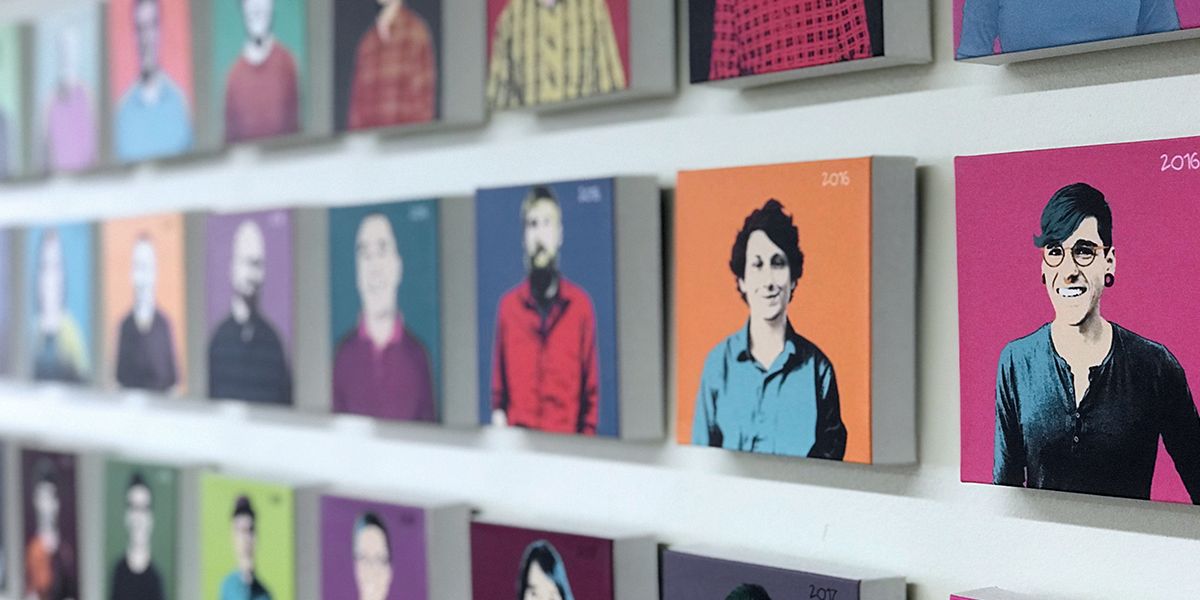 A wall of photos of MojoTech employees