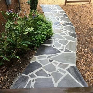 grey stone pavers beside a pool