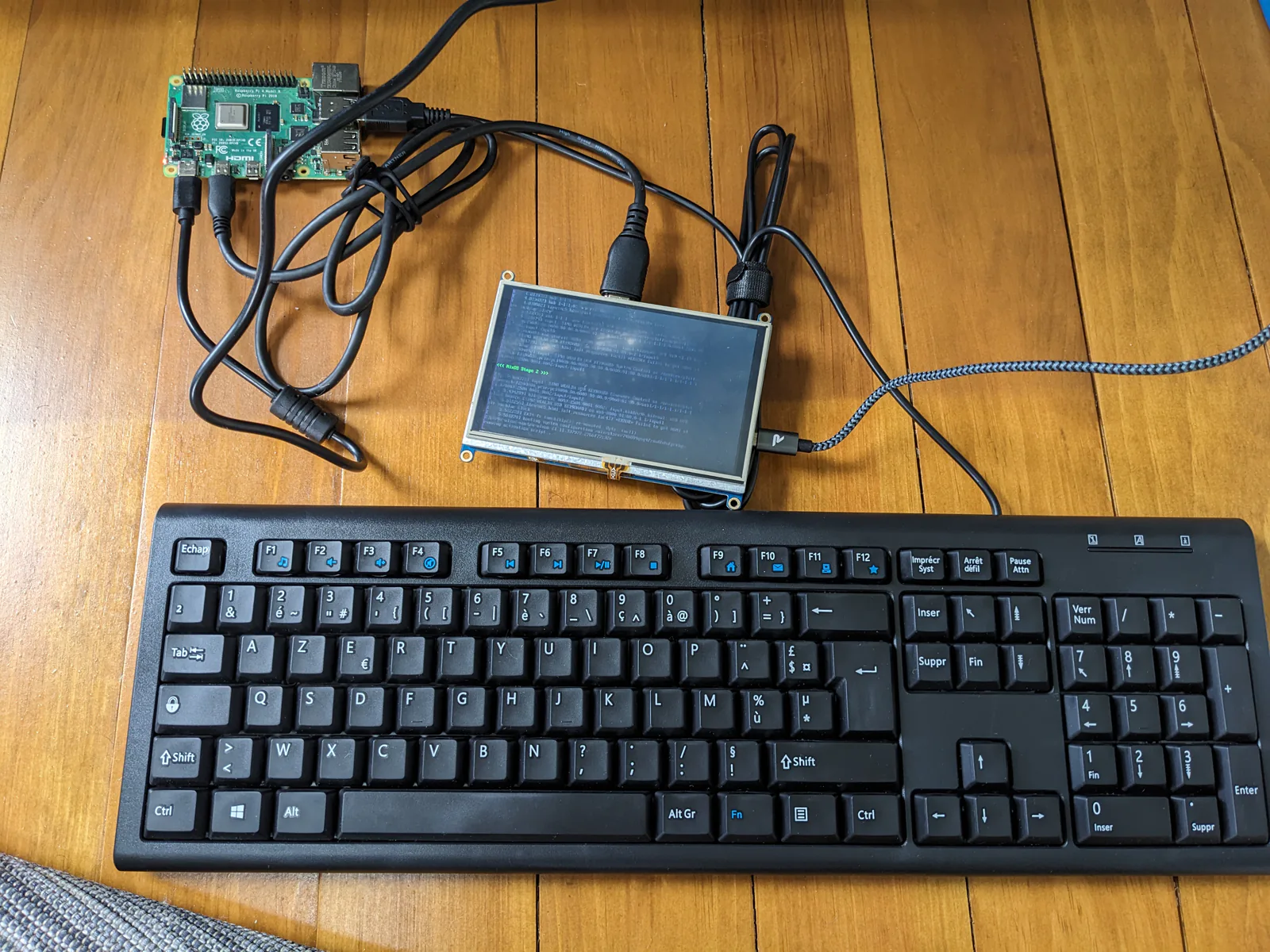 Photo of HDMI display and keyboard connected to a Raspberry Pi as it boots NixOS