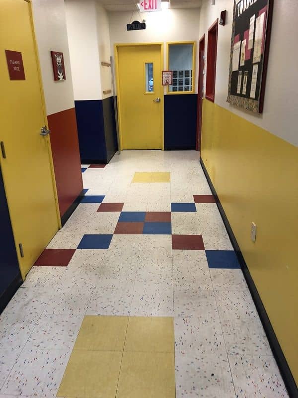 enlarged photo of yellow painted doors with a red, blue, and yellow strip painted wall
