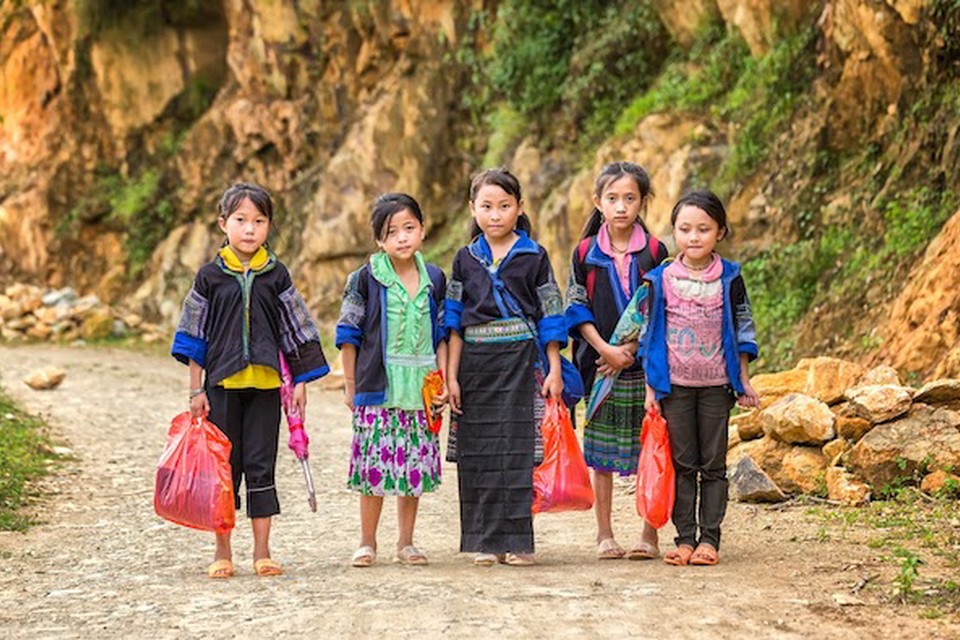 Students like these rural Vietnamese school children carrying books in plastic bags benefit from education nonprofit organizations.