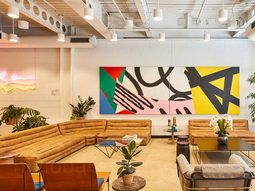 Spacious meeting space with artistic decoration and large brown corner sofa Microsoft Teams background