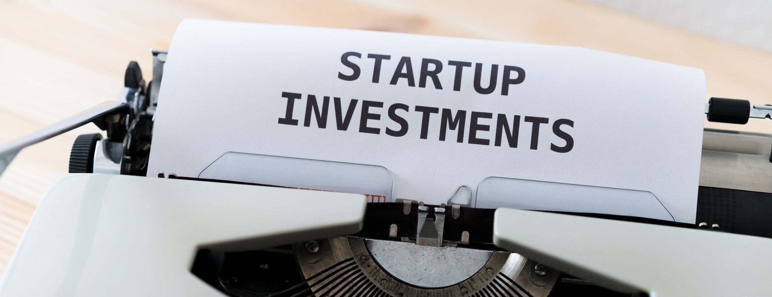 startup investments text on a typewriter