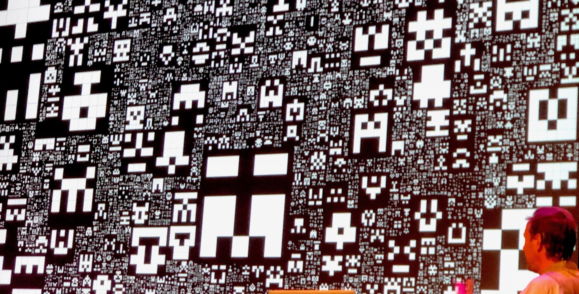 Miriam showing a slide of the CSS Grid generated art inspired by Jared Tarbell