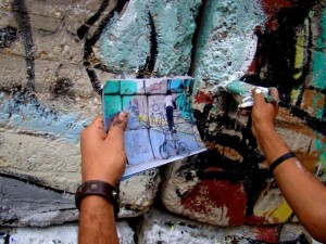 [Ammar Abo-Bakr uses a real photograph to replicate the scene at the Sheikh Rihan Street wall.]