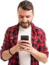 A man in a checked shirt looking at his phone