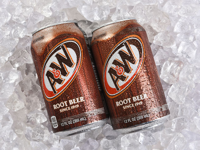 Two cold cans of A&W Root Beer laid over a bed of ice