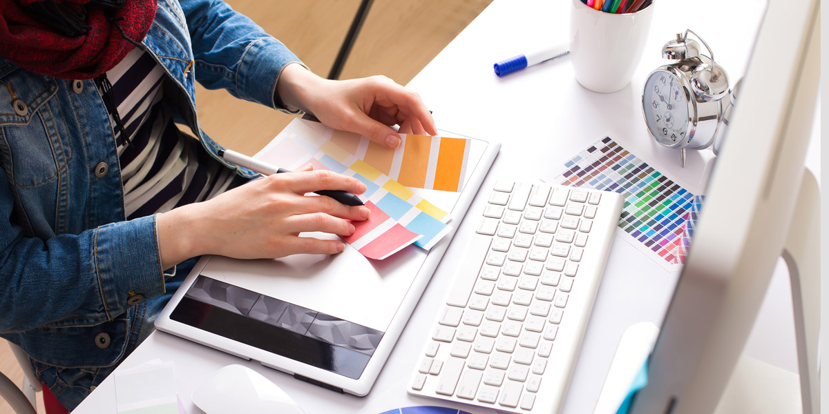 UI designer choosing a color palette UI designer picking a color palette and working on wireframes on an iMac