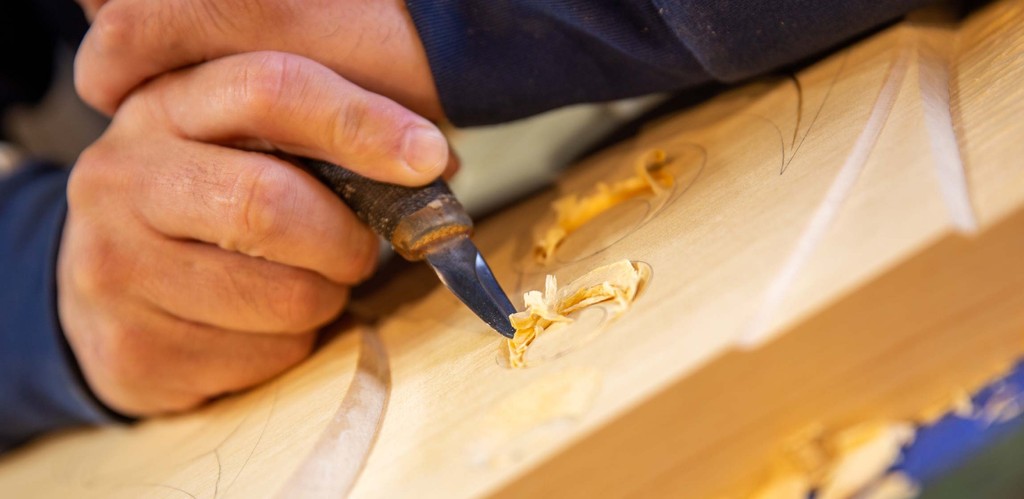 Detail of Musqueam artist Brett Sparrow carving into wood