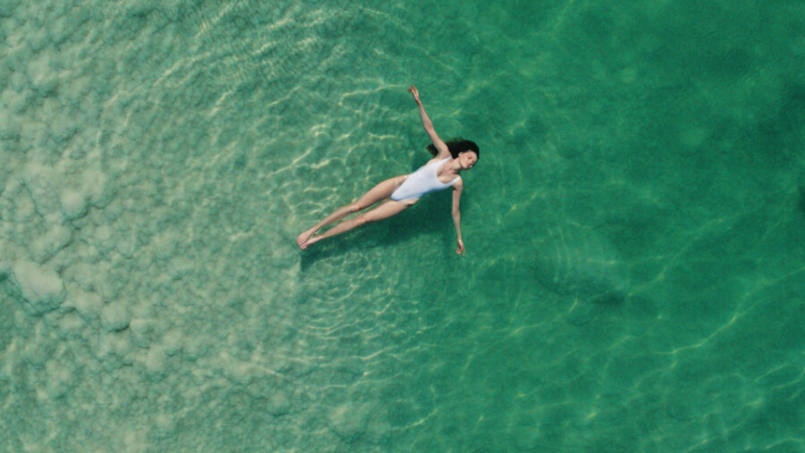 Arial view of woman laying in the Dead Sea.