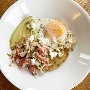 Breakfast tostada with cabbage and radish slaw