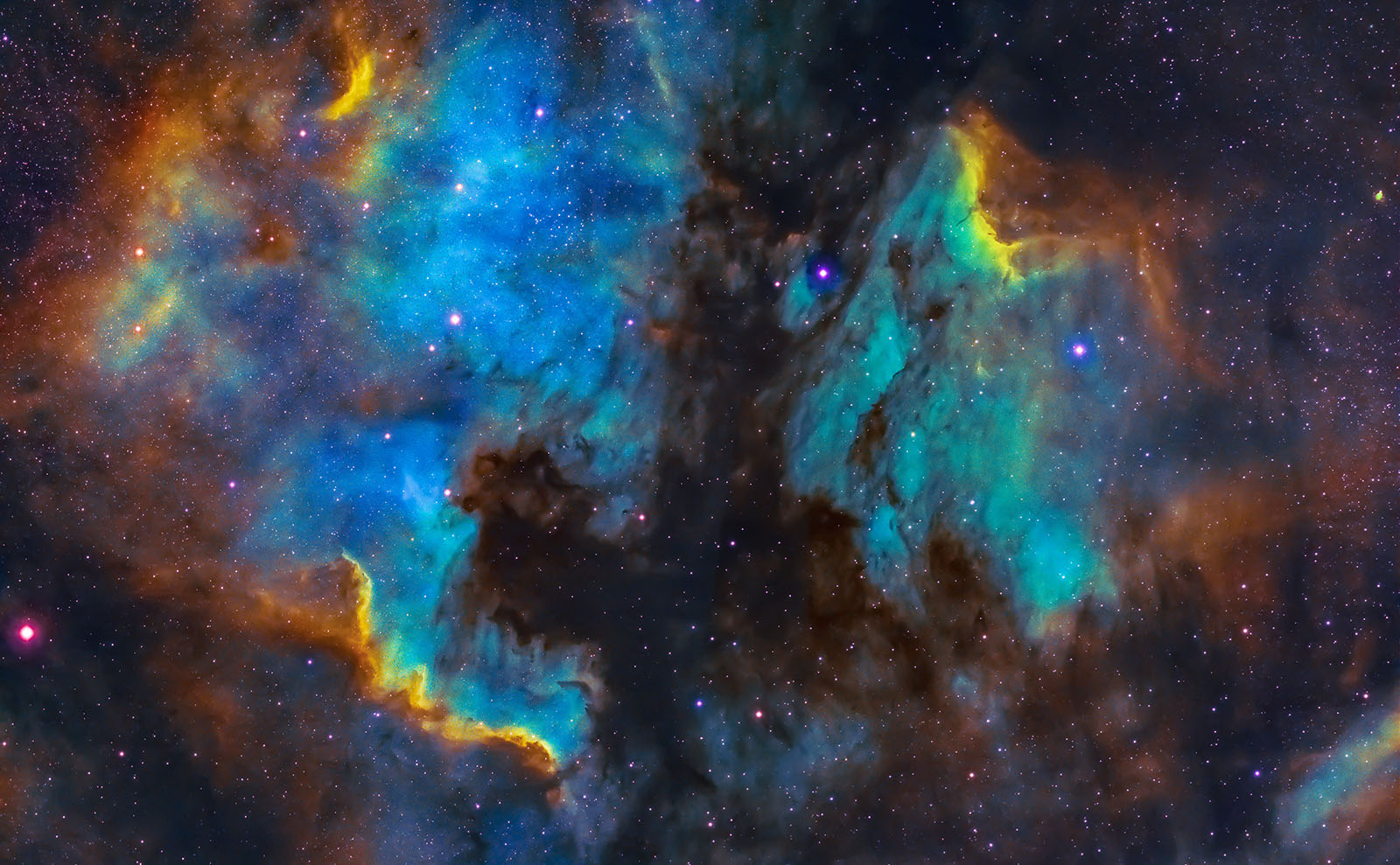 image of outer space with multicolored swirls of the north american and pelican nebulae mosaic