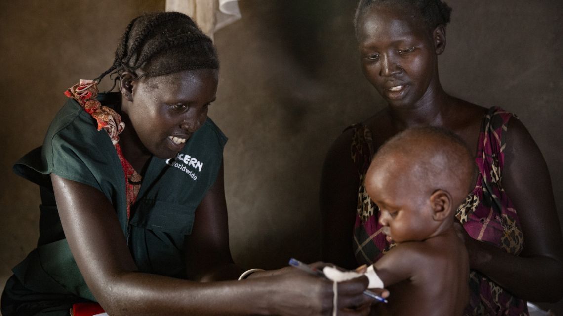 A community healthcare worker in Ethiopia screens a young boy for malnutrition