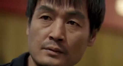 A close-up screenshot of a stern looking man (playing by Lee Eol). From the Kim Ki-duk film 'Samaritan Girl'.