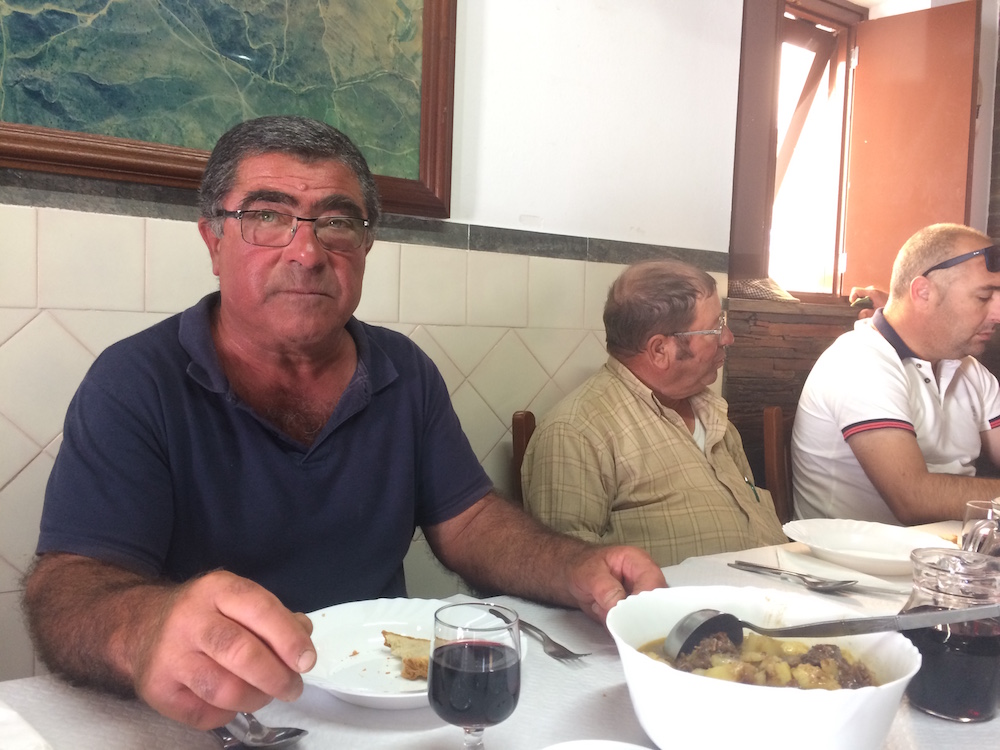 João Correia enjoys a duck stew lunch with his friends in a local restaurant in Aldeia da Luz.
